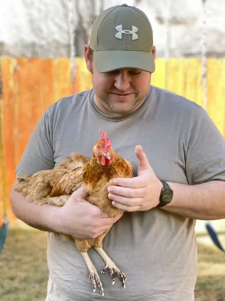 Picture of Rick Kesler holding a chicken named "Sunrise"